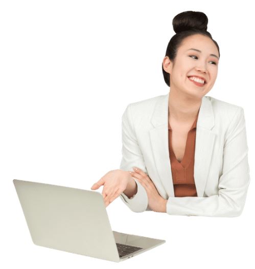 a woman wearing a bun, a white blazer and brown shirt sits in front of a laptop