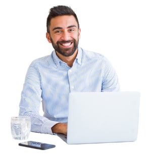 Man sitting in front of a laptop smiles at the camera