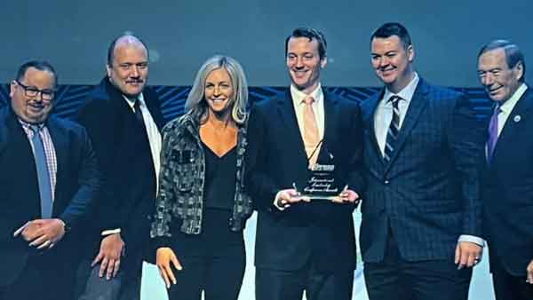Five Specialized Recruiting Group Owners hold award on stage at International Leadership Conference accompanied by Express Employment Professionals CEO.