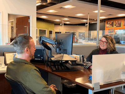 Express staff speaking with a client about job placement needs