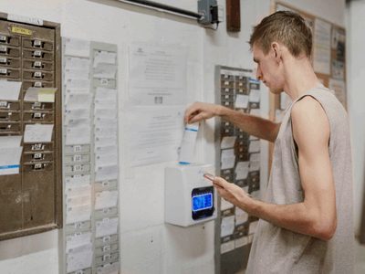 Man Punching Time Card to Start Work