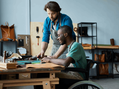 Man training another in a skilled trade