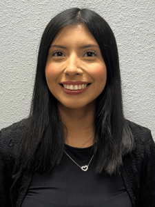 Professional photo of a female with black hair wearing a black top