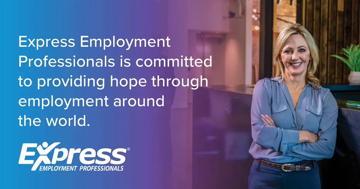Photo of adult woman with blonde hair in blue blouse standing with arms crossed and smiling indoors; text: “Express Employment Professionals is committed to providing hope through employment around the world.” and logo “Express Employment Professionals”.
