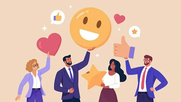 Four business professionals standing together holding large icons representing positive feedback, including a smiling emoji, a heart, a star, and a thumbs-up symbol, with speech bubbles showing likes and ratings.