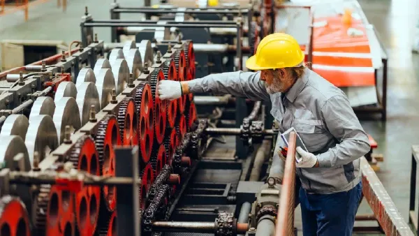 Man in hardhat working in factory