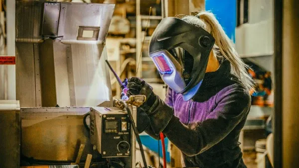 Woman with a welding mask working