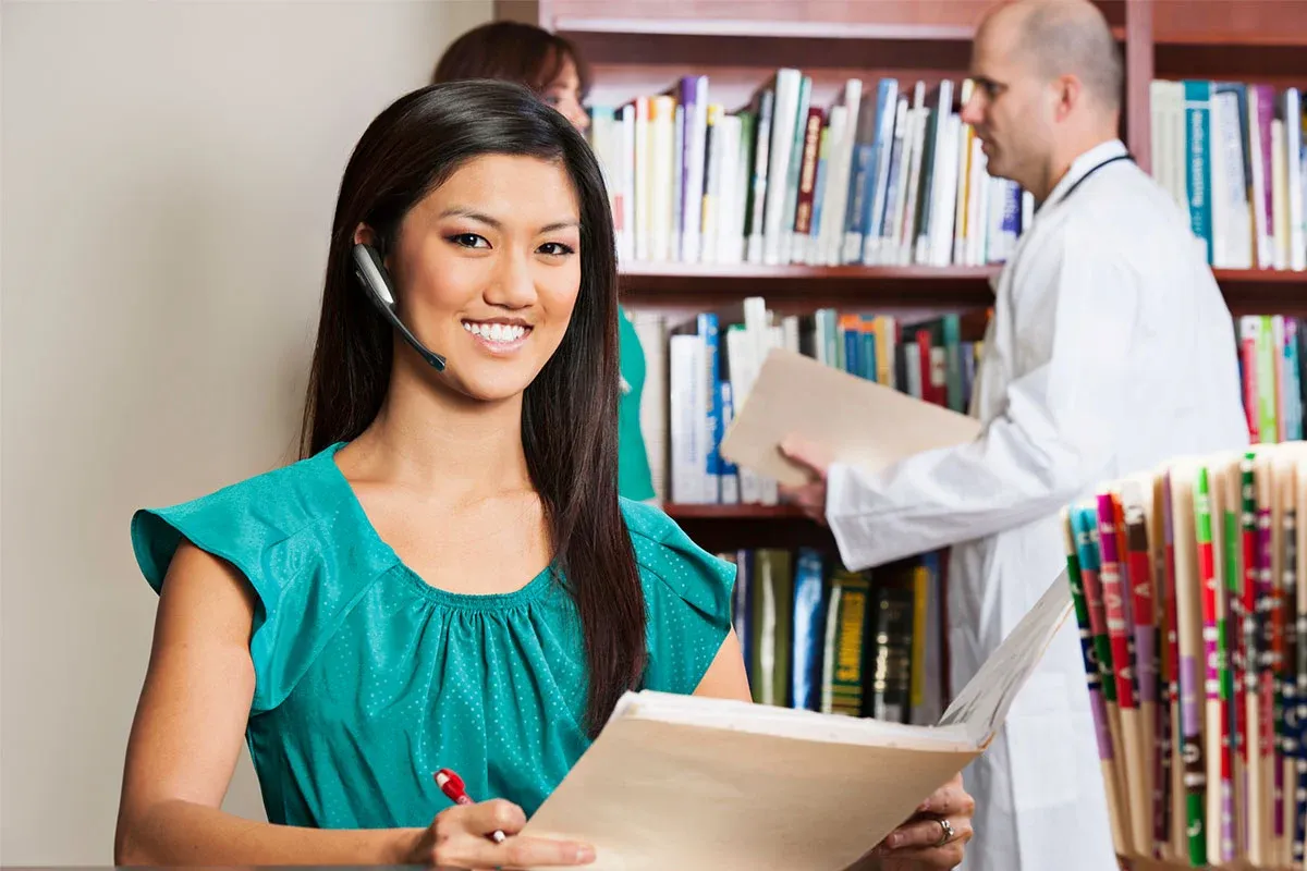 Woman smiling holding medical files
