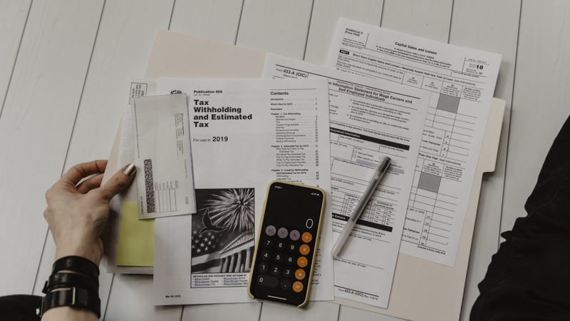 Payroll specialist reviewing paperwork for a Fremont CA small business