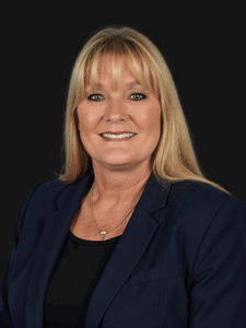 Professional photo of Kristie. She is a woman with blonde hair. She is dressed in business professional clothes. 