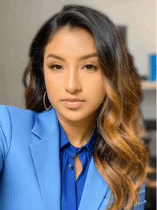 Professional photo of a female with brown hair wearing a blue blouse with a light blue blazer