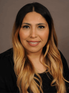 Professional photo of a woman with brown hair wearing a black blouse