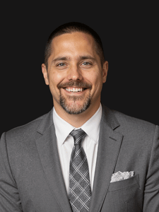Professional photo of Jacob, a middle aged man dressed in business professional clothes.
