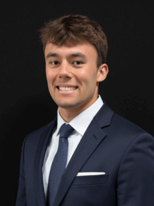 Professional photo of Josh, a young man with dark hair dressed in business professional attire.