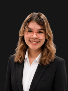 Professional photo of Kenzy. She is a young woman dressed in business professional clothes. She has brown hair.