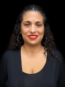 Headshot of a female recruiter with black curly hair, red lipstick, and wearing a black blouse