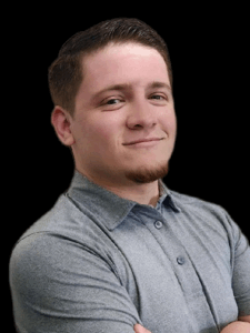 Professional photo of a young man with short brown hair and a grey polo 