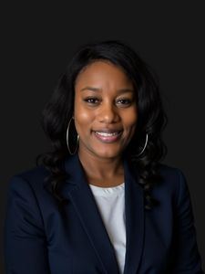 Professional photo of Shenitra, Shenitra. She is a young woman with dark hair. She is dressed in business professional clothes. 
