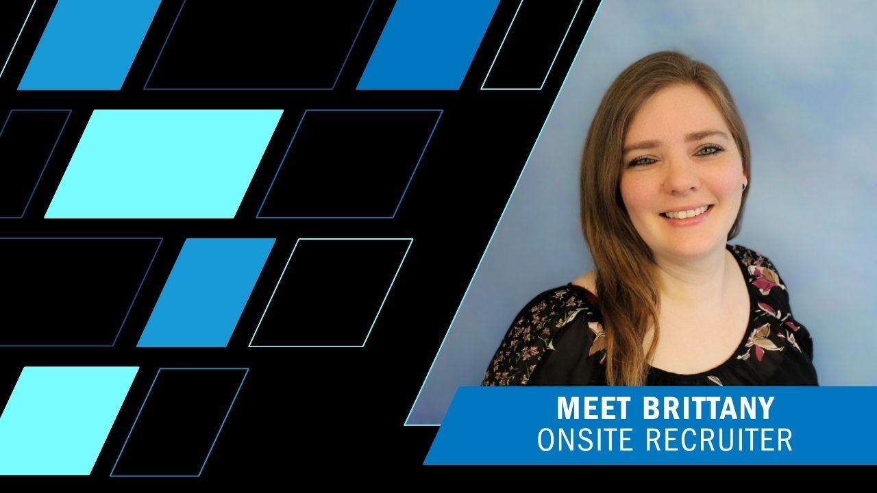 Image of Brittany, the Onsite Recruiter at Forgent Power Solutions, wearing a black shirt with magenta and cream flowers, long brown hair, blue eyes
