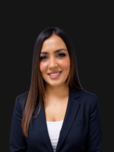 Professional portrait of Alma dressed in business professional attire and smiling.