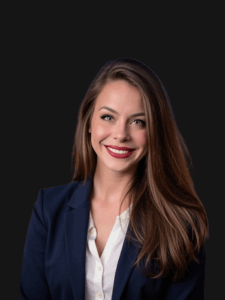 Portrait of Brittany dressed in business professional attire and smiling.