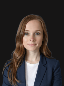 Portrait of Tambi dressed in business professional attire and smiling.